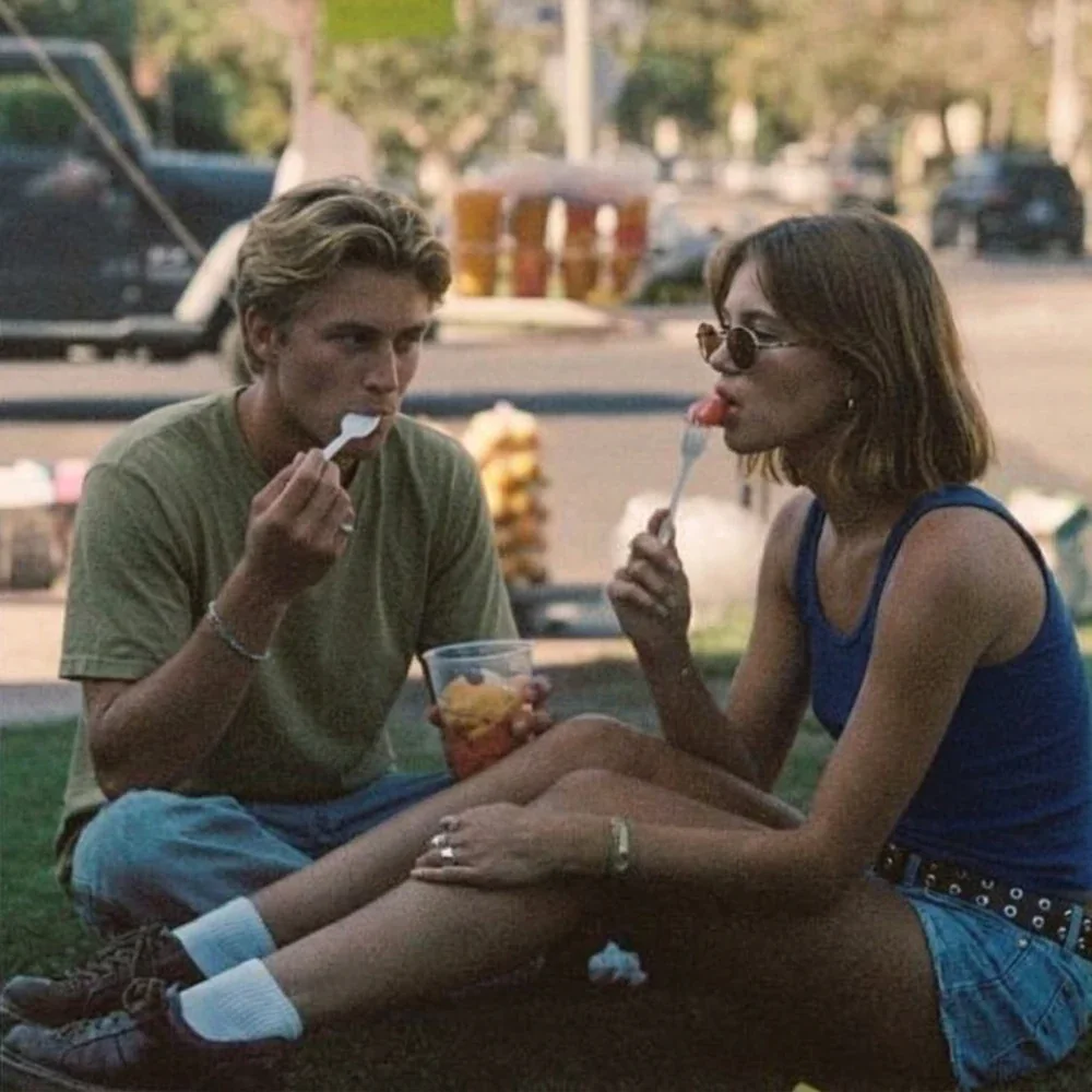 Two people sharing a snack in the park